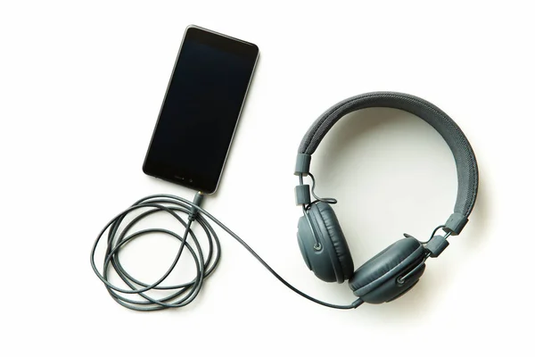 Gray vintage headphones and cellphone. — Stock Photo, Image
