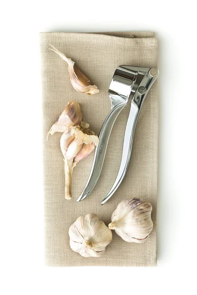 Garlic and garlic press. — Stock Photo, Image
