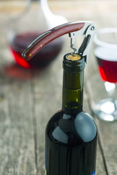 Bottle of wine with corkscrew. — Stock Photo, Image