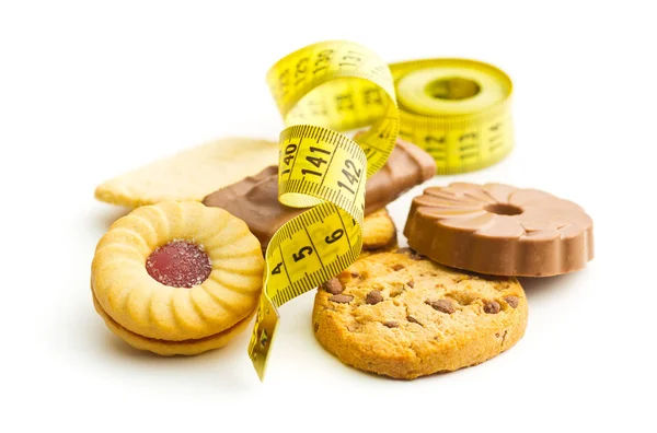 Sweet biscuits and measuring tape. — Stock Photo, Image