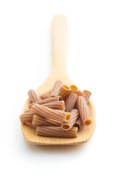 Dried rigatoni pasta on wooden spoon. — Stock Photo, Image