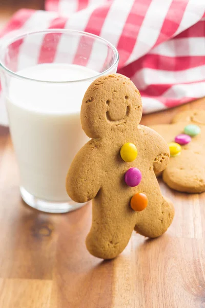 Sweet gingerbread man and glass of milk. — Stock Photo, Image