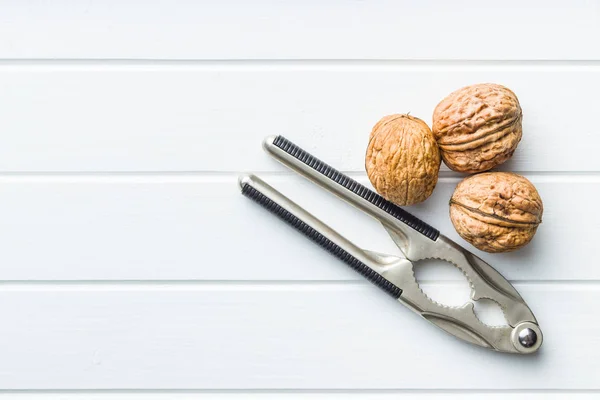 Tasty dried walnuts and nutcracker — Stock Photo, Image