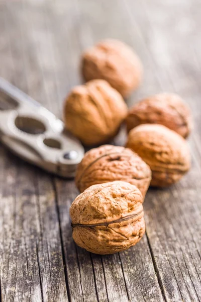 Tasty dried walnuts and nutcracker. — Stock Photo, Image