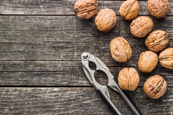 Tasty dried walnuts and nutcracker. — Stock Photo, Image