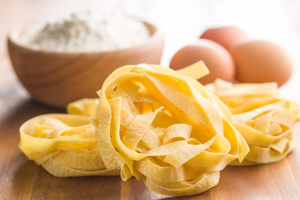 Raw tagliatelle pasta. — Stock Photo, Image