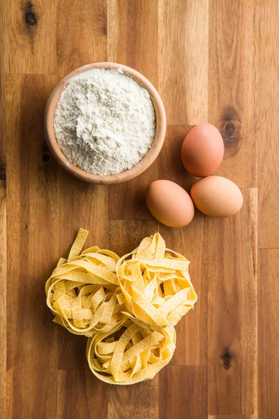 Raw tagliatelle pasta. — Stock Photo, Image