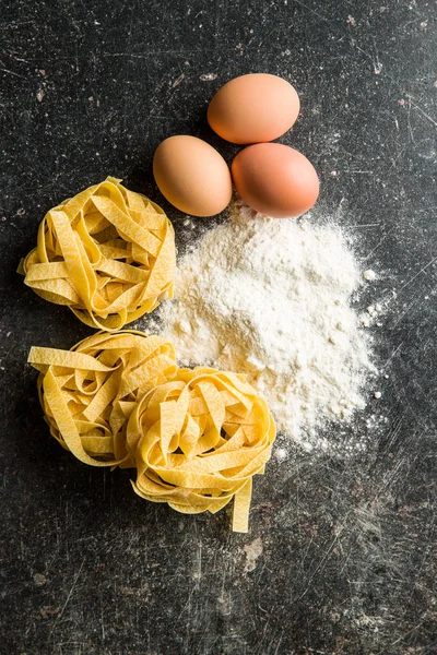 Raw tagliatelle pasta. — Stock Photo, Image