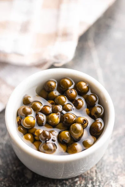 Green peppercorn in brine. — Stock Photo, Image