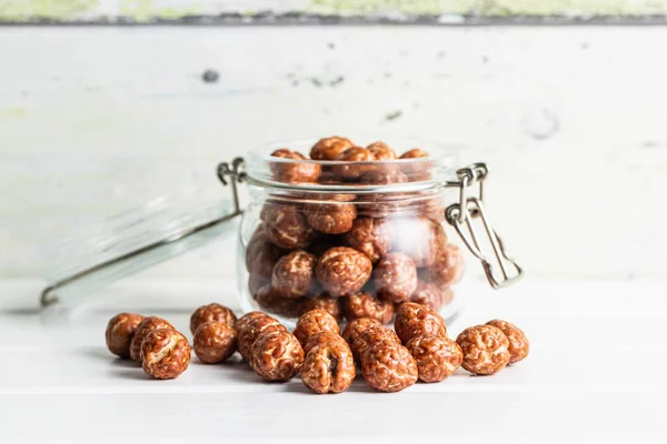 Hazelnuts Sugar Icing Jar White Table — Stockfoto