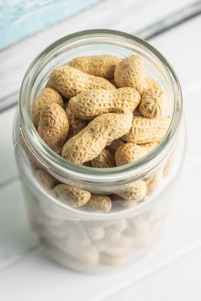 Tasty Unpeeled Peanuts Peanuts Jar White Table — Stock Photo, Image
