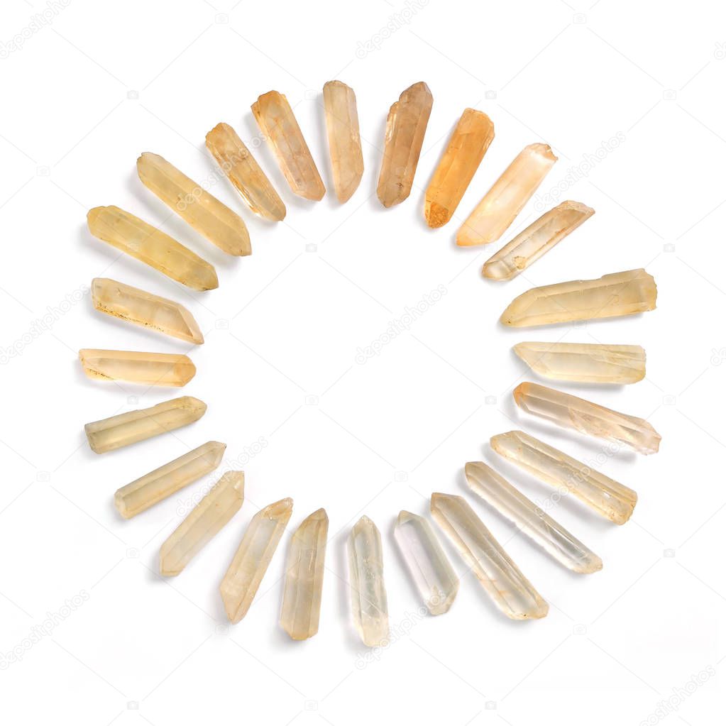 Circle frame of Lemurian Seeds quartz gemstones, powerful healing crystals, isolated on white background