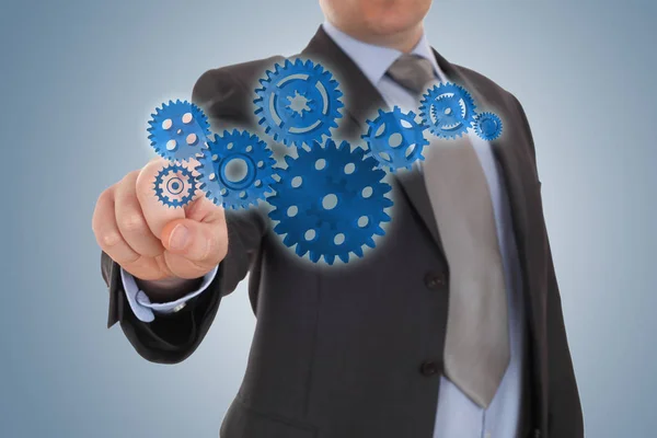 Businessman indicate a cog gear — Stock Photo, Image