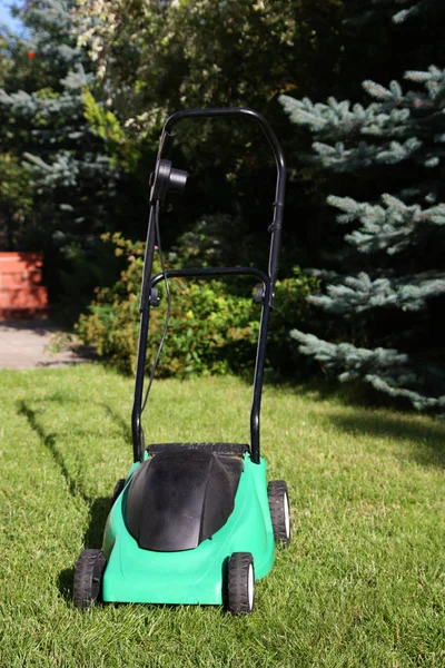 Lawn mower in the garden — Stock Photo, Image