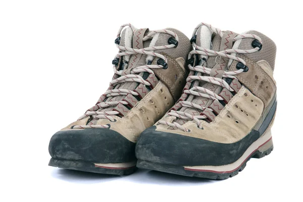 Old scuffed hiking boots on white background — Stock Photo, Image