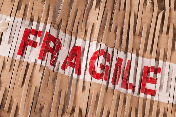 Fragile tape label across packaging — Stock Photo, Image