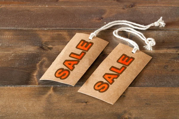 Two sale labels on a wooden table — Stock Photo, Image