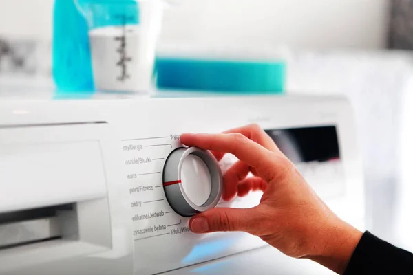 Woman hand adjusting washing machine — Stock Photo, Image