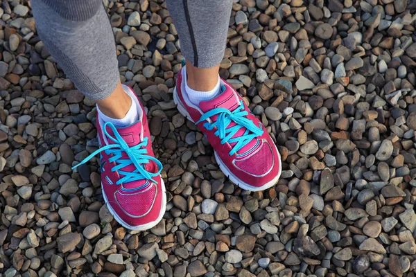 Pinkfarbene Sportschuhe auf Kies — Stockfoto