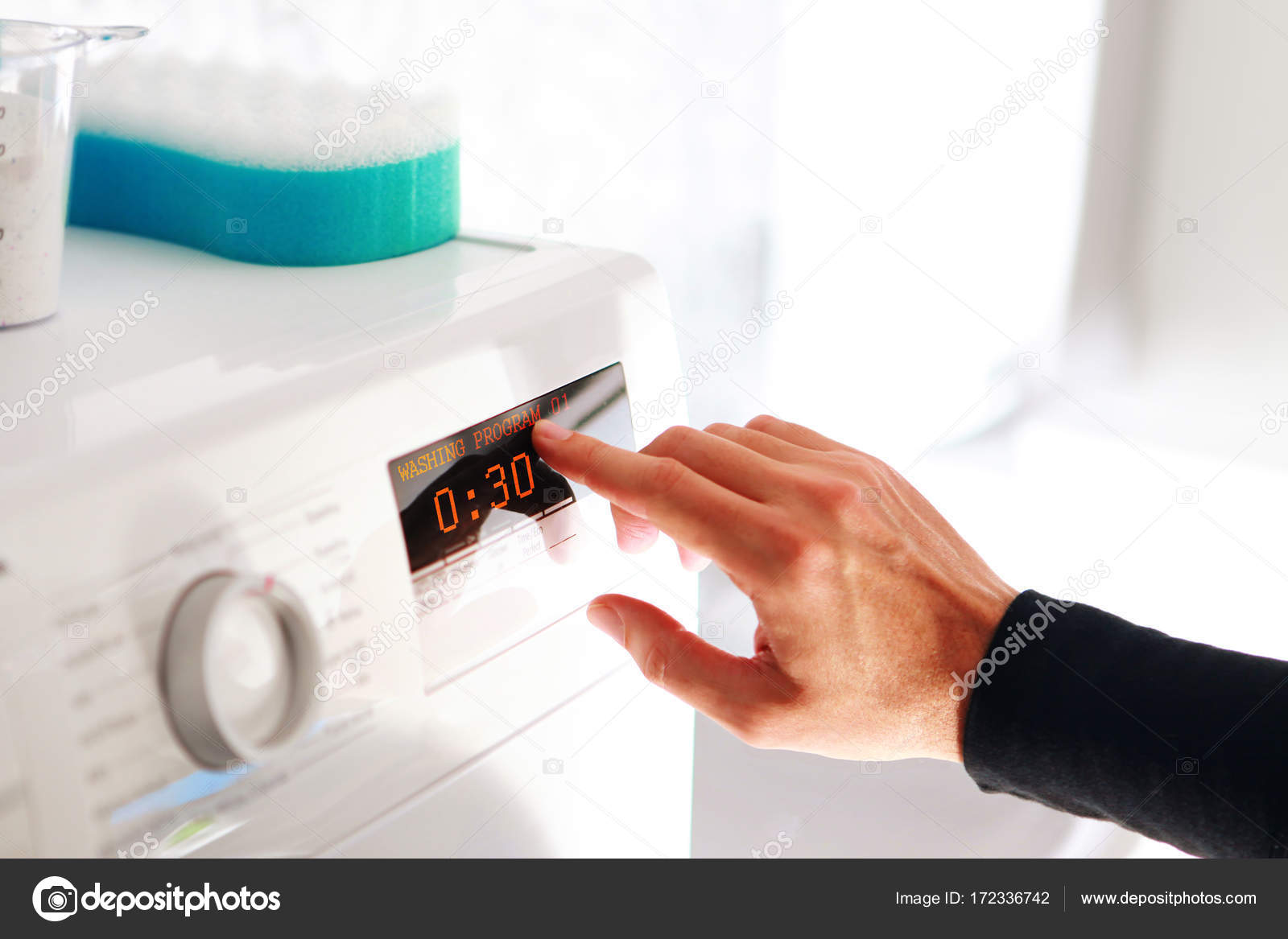 Man choosing program for washing machine — Stock Photo © ssuaphoto