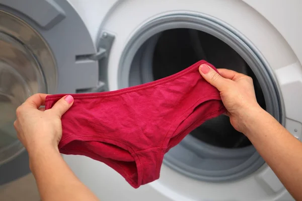 Shorts in hands for laundry — Stock Photo, Image