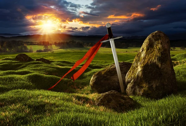 Sword in the dramatic sunny landscape. — Stock Photo, Image