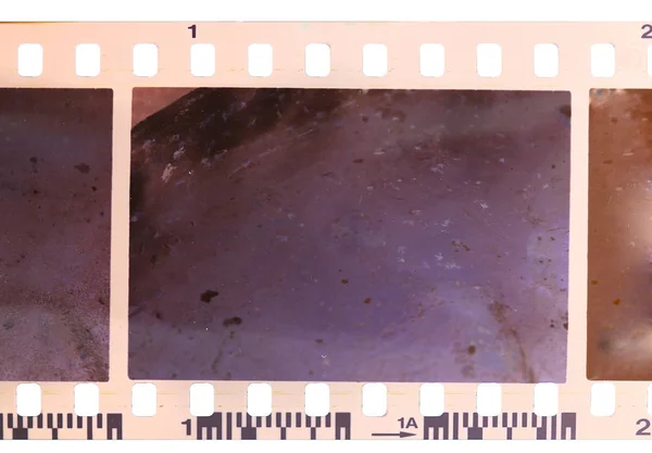 Strip of old, worn and bad developed color celluloid film — Stock Photo, Image