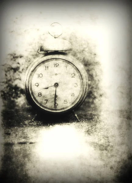 Old photo of the alarm clock - grained, scratched, overexposure — Stock Photo, Image