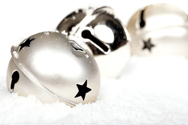 Silver jingle bells in the snow — Stock Photo, Image