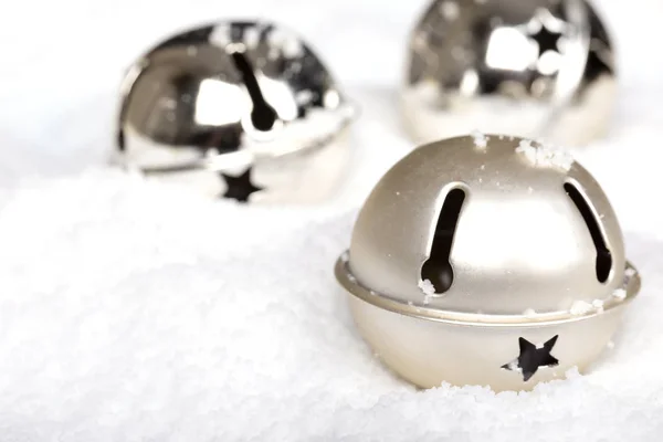 Silver jingle bells in the snow — Stock Photo, Image