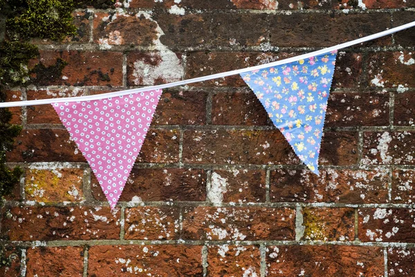 Bunting against old brick wall — Stock Photo, Image