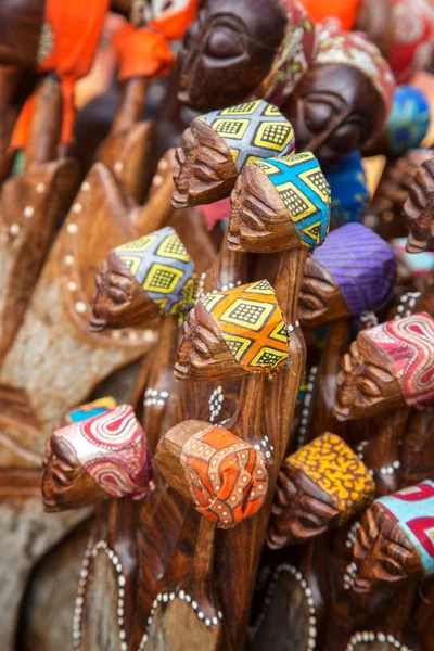 African tribal art for sale at a market stall.