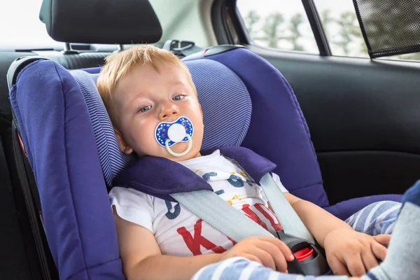 Little boy in car safety seat