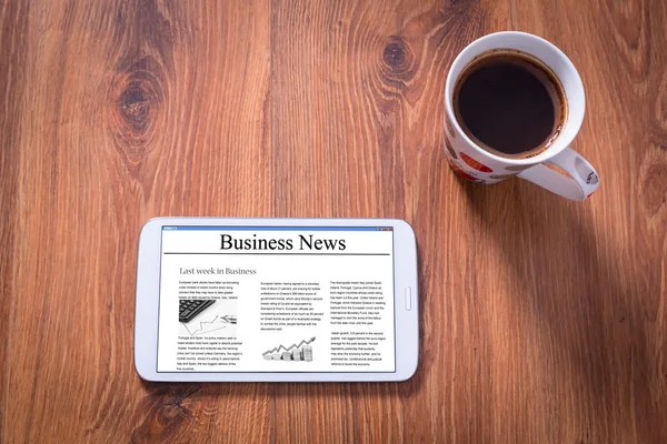 Tablet with business news and black coffee — Stock Photo, Image