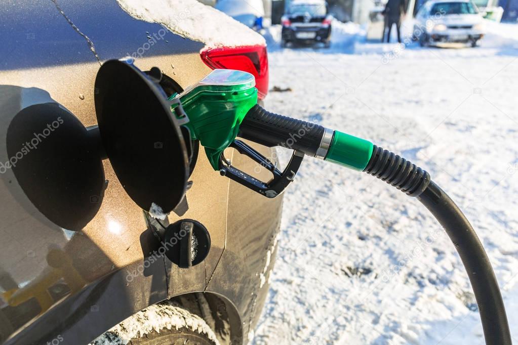 Car refill with petrol on the gas station