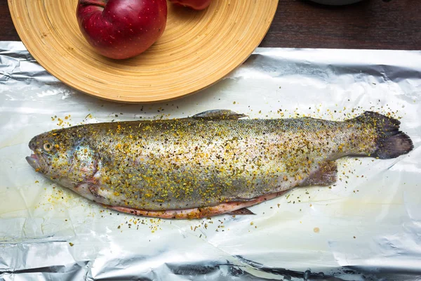 Whole rainbow trout on cooking foil — Stock Photo, Image