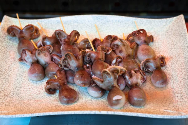 Raw octopus on sticks — Stock Photo, Image