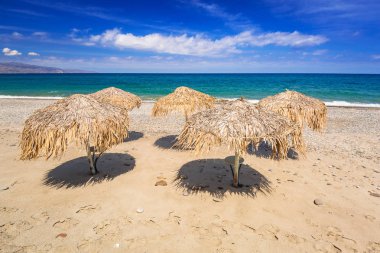 Girit Maleme plajda tropikal şemsiye