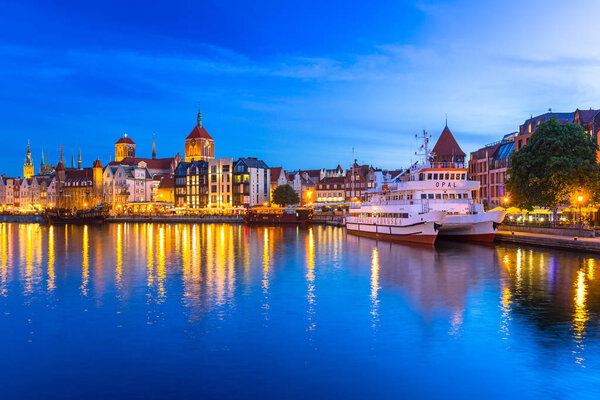 Architecture of the old town in Gdansk over Motlawa river at night