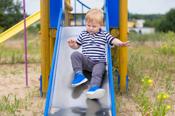 Little boy on the slide