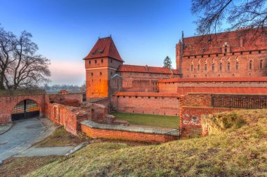 The Castle of the Teutonic Order in Malbork at dusk clipart