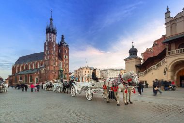 Horse carriages at the Main Square in Krakow clipart