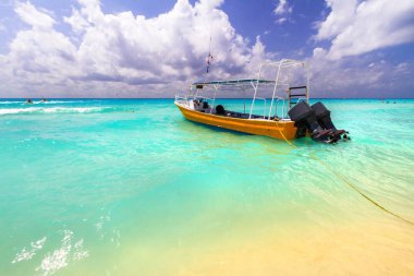 Yellow speedboat on the beach of Caribbean Sea in Mexico. clipart