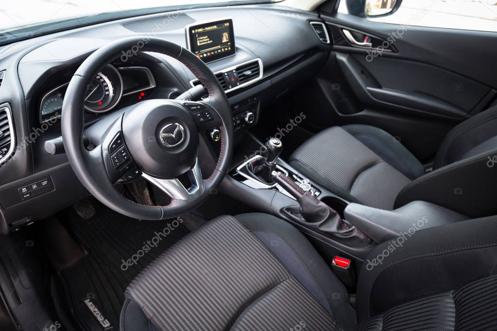 POLAND - FEBRUARY 11, 2018: Black interior of Mazda 3 captured in winter time. Mazda 3 is a popular compact car manufactured in Japan by the Mazda Motor Corporation.