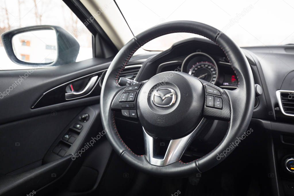 POLAND - FEBRUARY 11, 2018: Black interior of Mazda 3 captured in winter time. Mazda 3 is a popular compact car manufactured in Japan by the Mazda Motor Corporation.