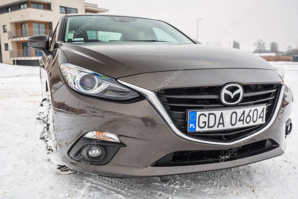 POLAND - FEBRUARY 11, 2018: Compact car Mazda 3 captured in winter time. Mazda 3 is a popular compact car manufactured in Japan by the Mazda Motor Corporation.
