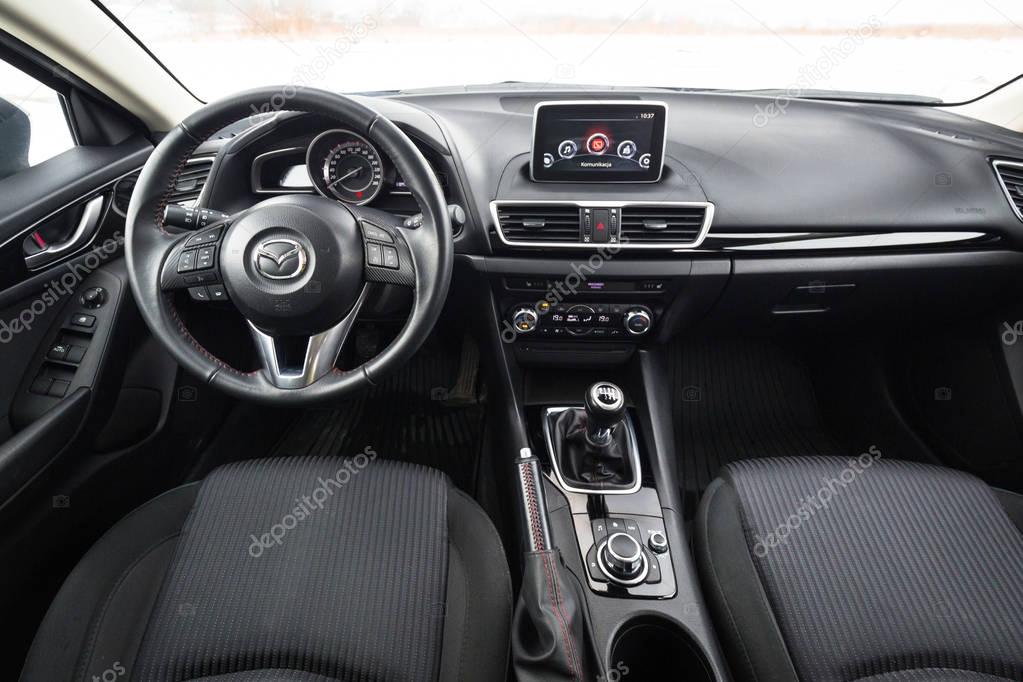POLAND - FEBRUARY 11, 2018: Black interior of Mazda 3 captured in winter time. Mazda 3 is a popular compact car manufactured in Japan by the Mazda Motor Corporation.