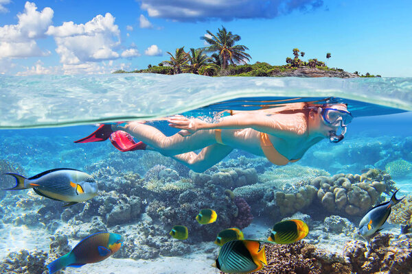 Young woman at snorkeling in the tropical water