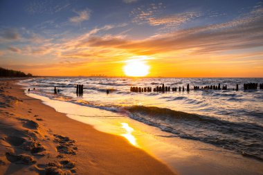 Sunset ovet the Baltic sea beach in Poland clipart