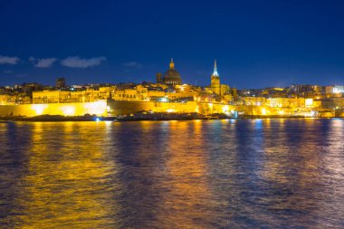 Malta kıyıları ve gece Valletta şehrinin mimarisi.